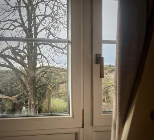 an open door with a view of a tree at Bi&Babette in Cocconato