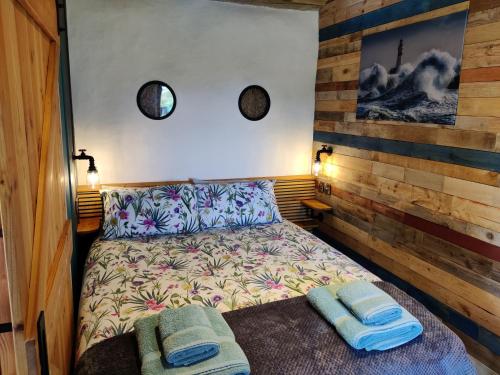 a bedroom with a bed with two towels on it at Wildflower Eco Lodges in Fraserburgh
