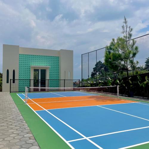 a tennis court in front of a building at Valle Verde Villas in Bandung