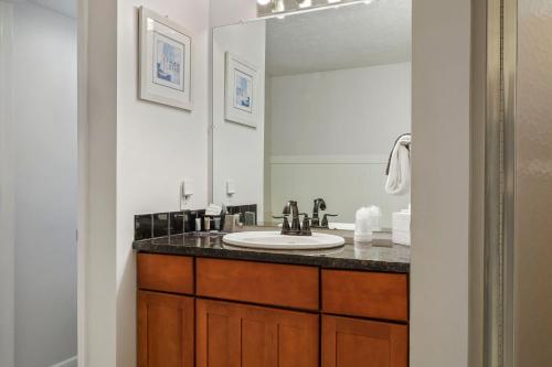 a bathroom with a sink and a mirror at 105 Pointes North Inn in Charlevoix