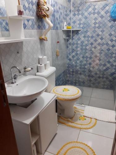 a bathroom with a white sink and a toilet at Cantinho do sossego in Paraty