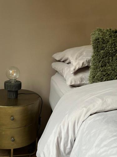 a bedroom with two beds and a lamp on a nightstand at W9 Gem Stylish 2 Bed Flat in London