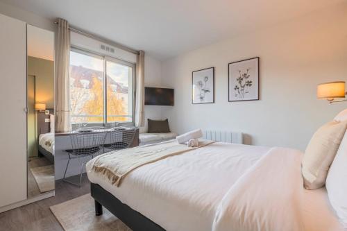 une chambre avec un grand lit blanc et un bureau dans l'établissement Studio proche Université Catholique & centre-ville, à Lille