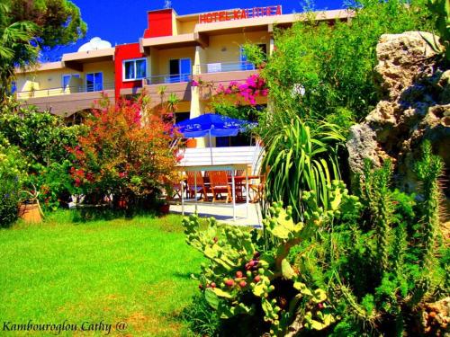 a building with a yard with plants and a house at Hotel Kalithea in Kallithea Rhodes