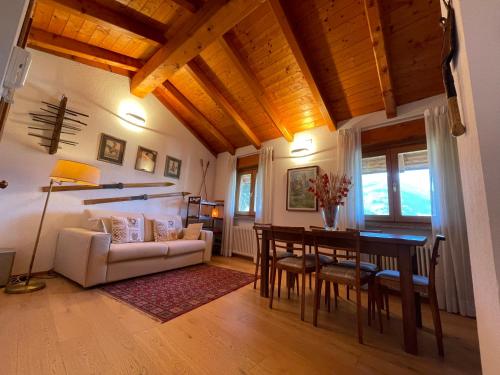 a living room with a white couch and a table at La Maison Vieille in Saint Vincent