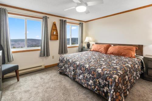 a bedroom with a bed and a large window at ML184 1st Floor No Elevator EZ Gated Parking WiFi in Snowshoe