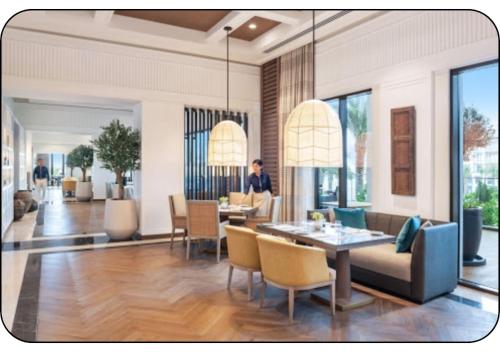 a living room with a table and chairs at Address Beach Resort Fujairah - Apartments in Fujairah