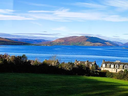 a view of a large body of water with houses at Bella Vista Manor - with elevated views over Rothesay & Loch Striven in Rothesay