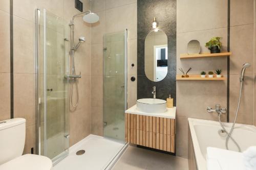 a bathroom with a shower and a sink and a toilet at Apartament Blues, ul Jastrzębia in Lublin