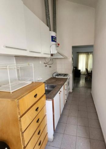 a kitchen with a sink and a stove top oven at Apart More in Villa Mercedes
