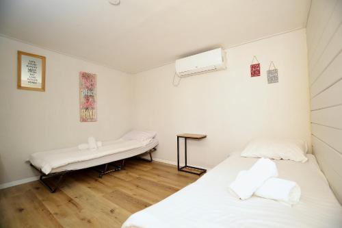 a room with two beds and a window and a heater at פרדייז ריזורט in Had Nes