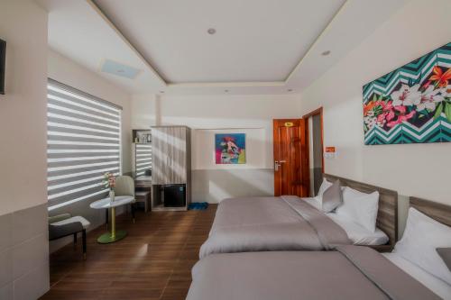 Postel nebo postele na pokoji v ubytování Dreamy Hotel Dalat