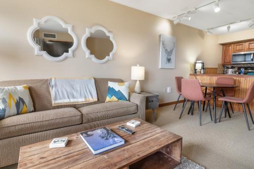 a living room with a couch and a table at Highland House 119 Next To Slopes Trails WiFi In Village With A View in Snowshoe