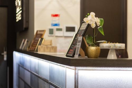 a counter with a flower on top of it at The Loft Budapest in Budapest