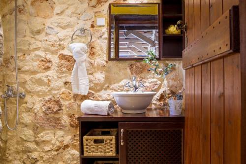 a bathroom with a sink and a bowl on a counter at Verekinthos Villas in Yerolákkos