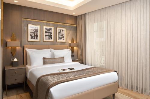 a bedroom with a large white bed and a window at Me by Mula in Istanbul