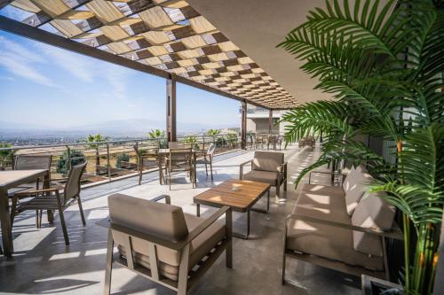 a restaurant with tables and chairs and a view at Hierapark Thermal & SPA Hotel in Pamukkale
