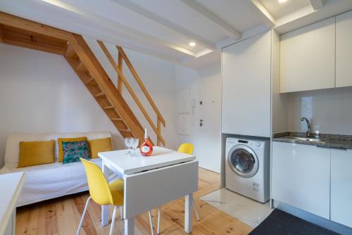 a kitchen and living room with a bed and a table at Host Wise - Sunny Bright Duplexes & Pool in Vila Nova de Gaia