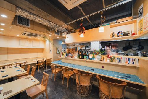 a restaurant with a counter and tables and chairs at Of Hotel in Sendai