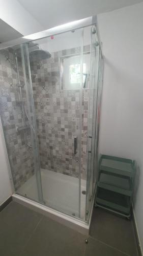 a shower with a glass door in a room at Casa Luna in Tolox