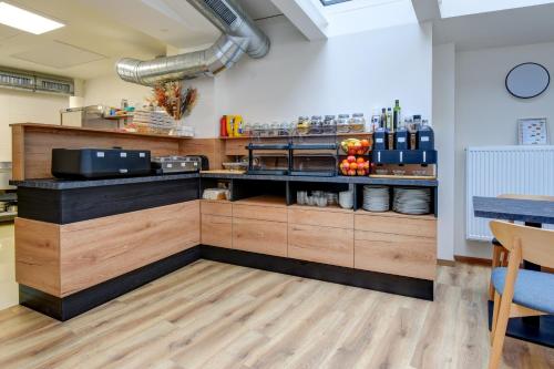 a restaurant kitchen with a counter with a counter top at Hotel Karlova Prague in Prague
