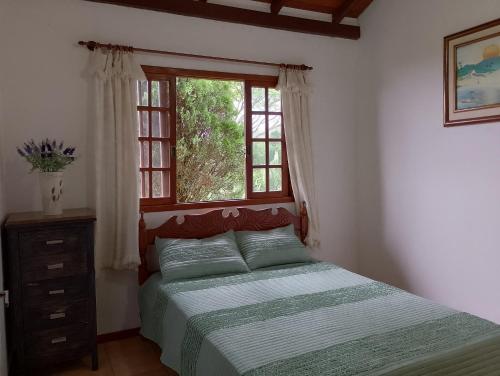 une chambre avec un lit et une fenêtre dans l'établissement Casa Vista Panorâmica, à Florianópolis