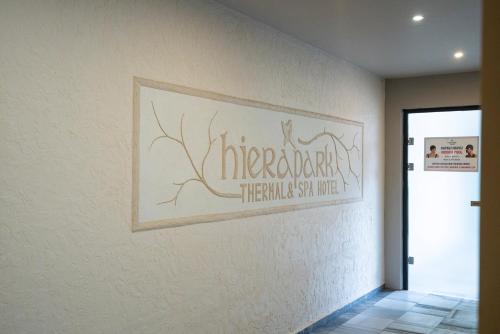 a sign on a wall in a hallway at Hierapark Thermal & SPA Hotel in Pamukkale