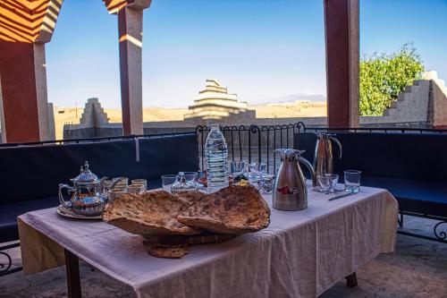 a table with bread and glasses on top at lmtounipalace in Ouarzazate