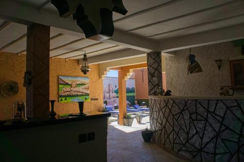 a kitchen in a house with a view of a yard at lmtounipalace in Ouarzazate
