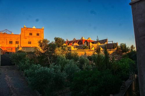 a large building in the middle of a city at lmtounipalace in Ouarzazate