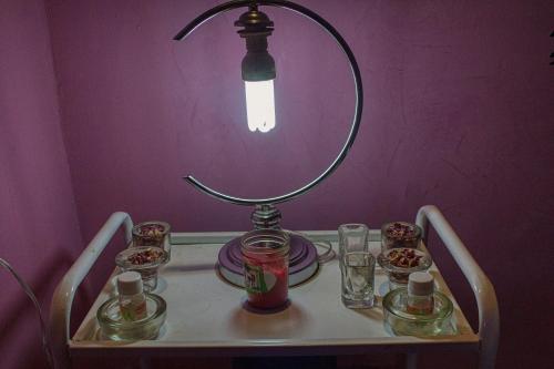a lamp sitting on a table with glasses on it at lmtounipalace in Ouarzazate