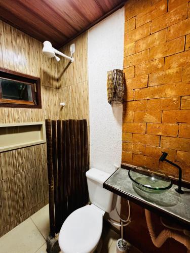a bathroom with a toilet and a sink at Duplex Villas Areias do Patacho - Praia do Patacho - Porto Pedras in Pôrto de Pedras