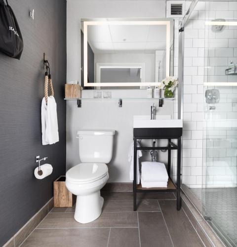 a bathroom with a toilet and a sink and a mirror at Harbor Court Hotel in San Francisco