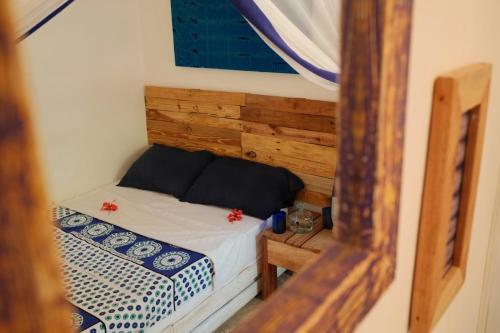 a small bedroom with a bed in a room at Salty's Kitesurf Village in Kilifi