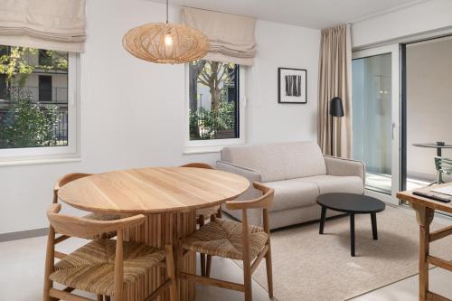 a living room with a table and a couch at Molum Hotel & Residences in Sveti Filip i Jakov