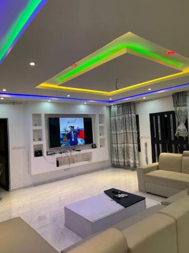 a living room with a couch and a tv at Tkj in Adidomé
