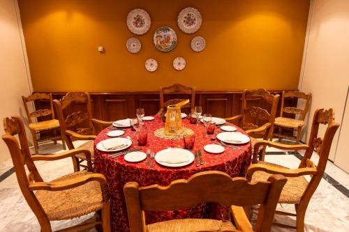 a dining room with a table with a red table cloth at AZZ Mérida Medea Hotel in Merida