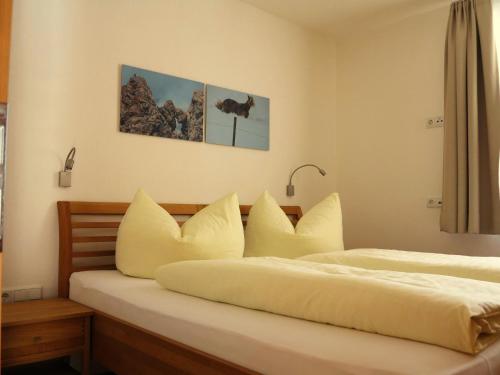a bedroom with two beds with white sheets and pillows at 4two in Galtür