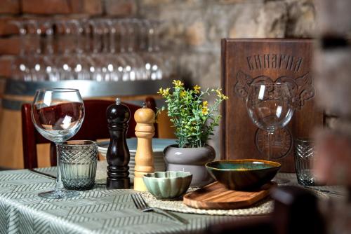 a table topped with wine glasses and a table cloth at Park Hotel Kaylaka in Pleven
