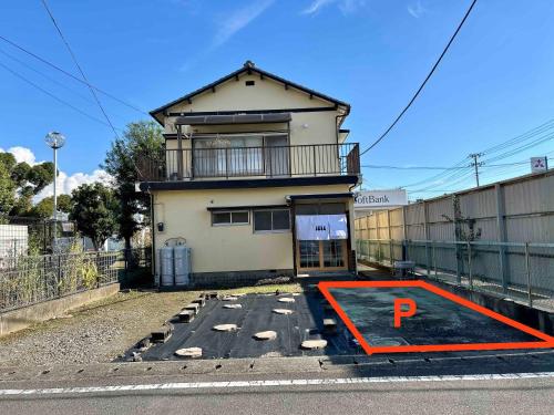 a building with a parking lot in front of it at Rabbit Inn in Fuji