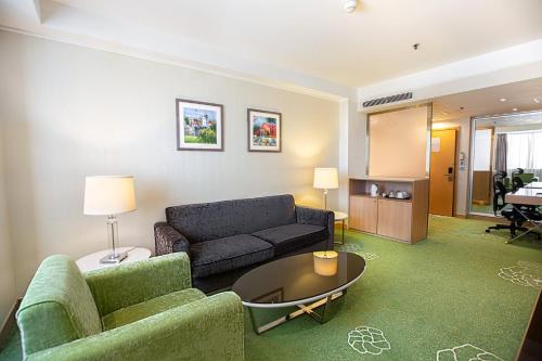 a living room with a couch and a table at Holiday Inn Macau by IHG in Macau