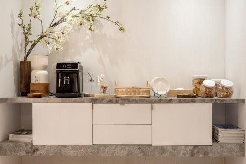 a counter with a coffee maker on top of it at suye hotel in Taichung
