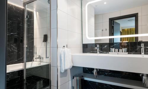 a bathroom with a sink and a mirror at Thon Hotel Orion in Bergen
