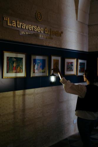 a woman taking a picture of a painting in a museum at Fiermonte Museum by La Fiermontina in Lecce