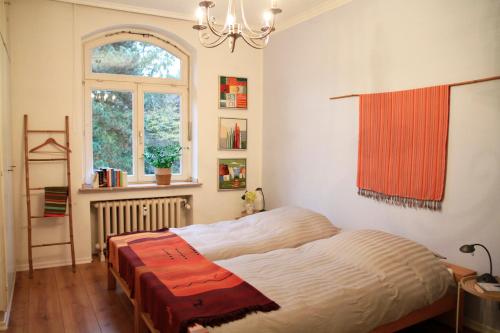 a bedroom with a bed and a window at Villa Kolck in Xanten