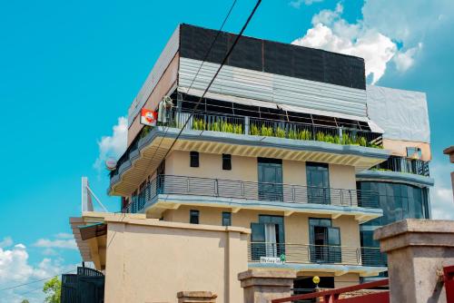 a building with a balcony with plants on it at Comfort View Guest House in Cyuve