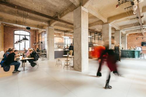 a group of people sitting at tables in a building at fabrik studio apartments in Chemnitz