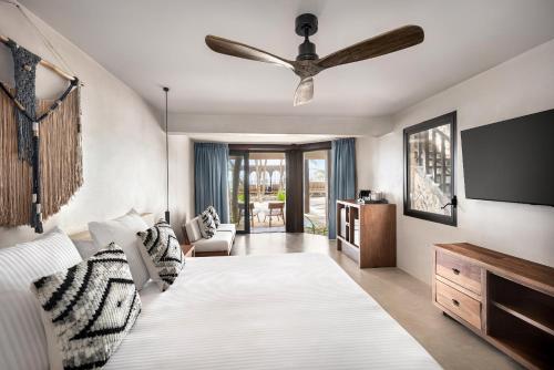 a bedroom with a bed and a ceiling fan at Secrets Tulum Resort & Beach Club - Adults Only - All Inclusive in Tulum