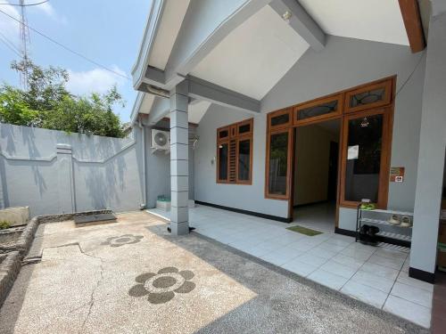 an outside view of a house with a patio at Dehome Pakuwon Mall 2 Syariah in Surabaya