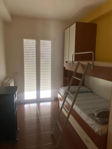 a small room with a bunk bed and a window at San Lorenzo beach in Marina di San Lorenzo